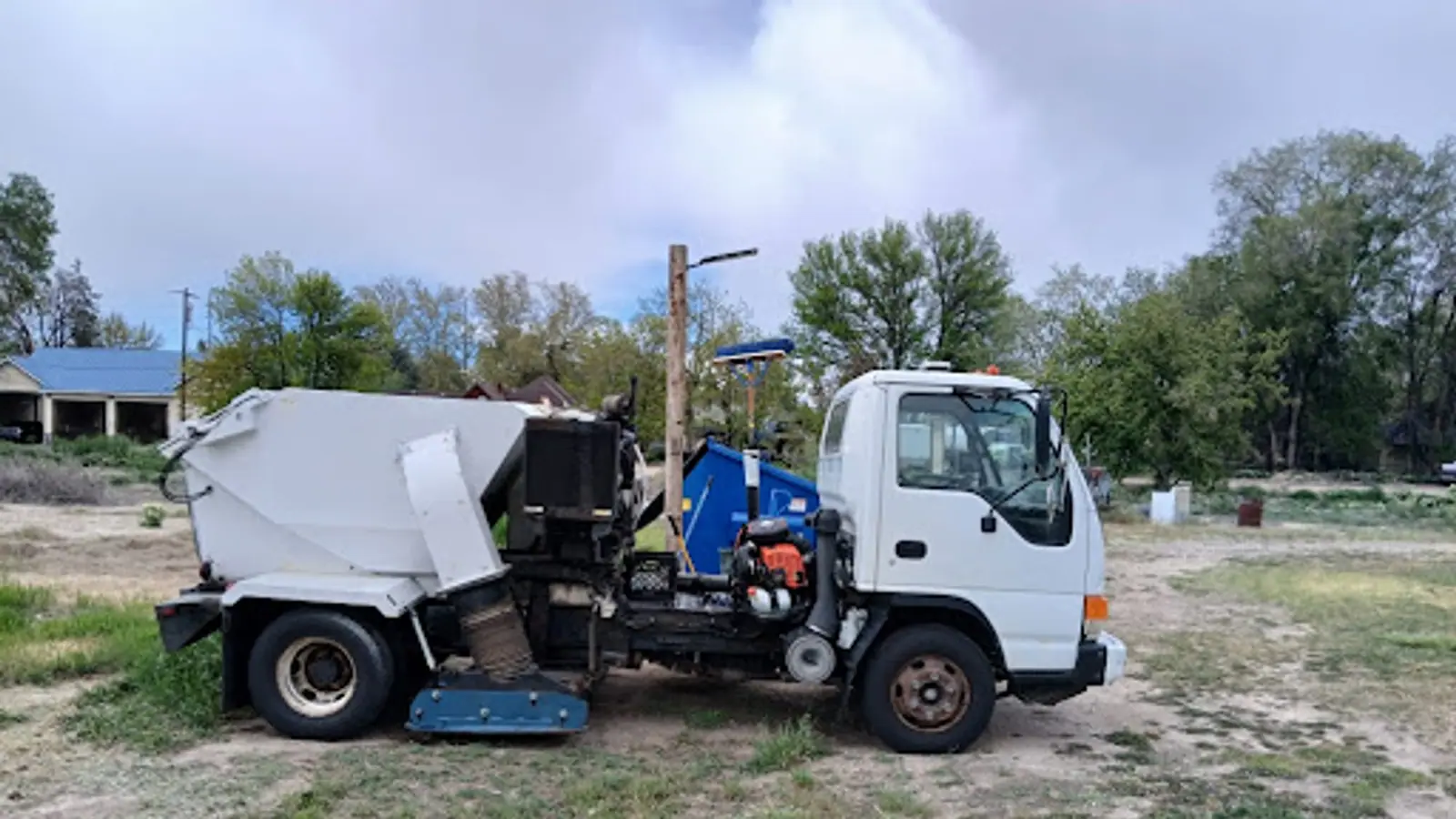 Sweep-A-Lot white cab-over sweeper truck with its blue pickup head